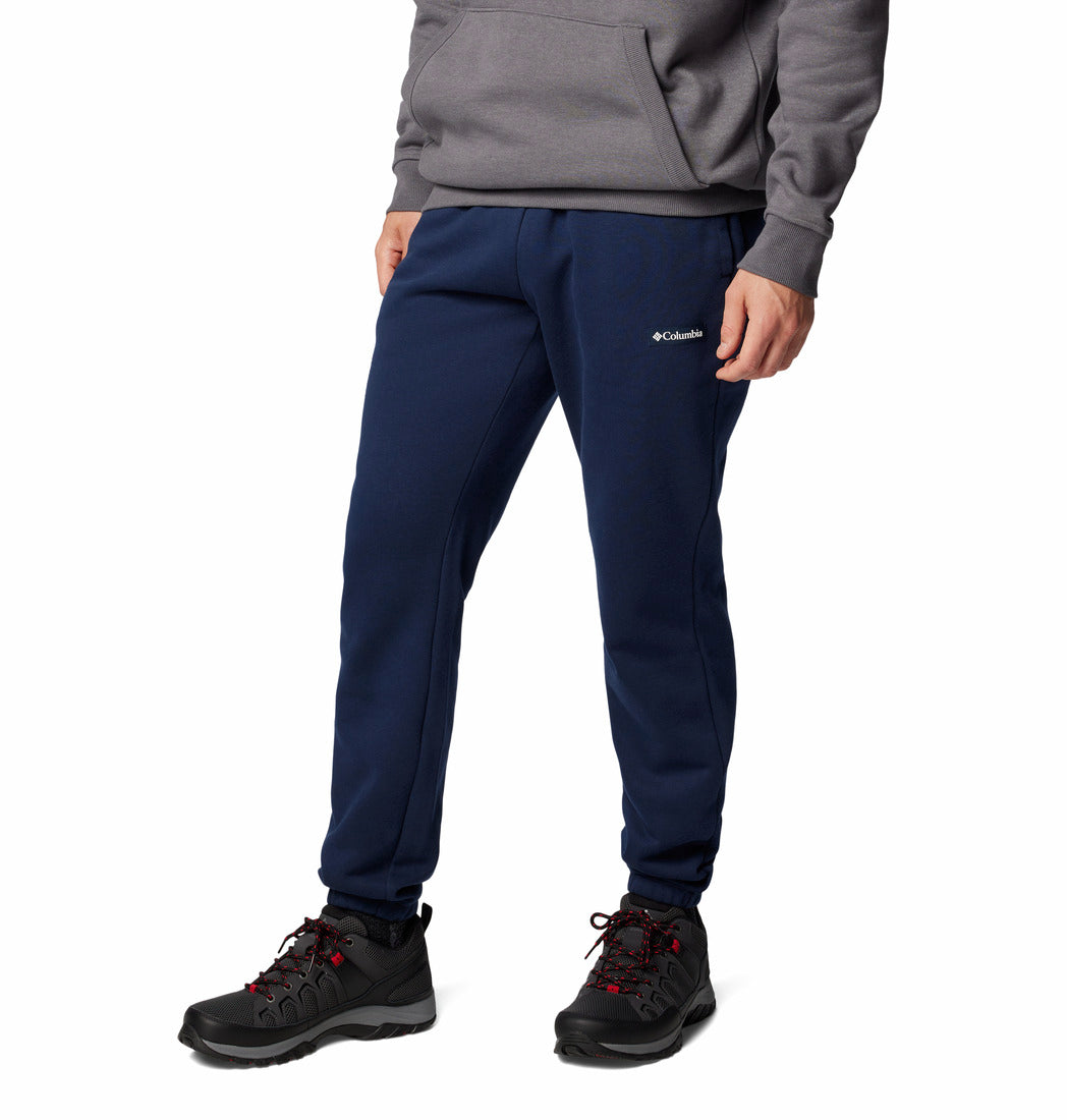 Person wearing navy Columbia sweatpants on a white background