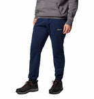 Person wearing navy Columbia sweatpants on a white background