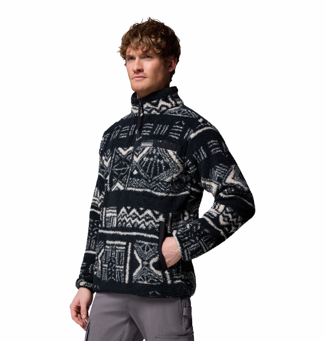 Person wearing a patterned black and gray pullover on a white background