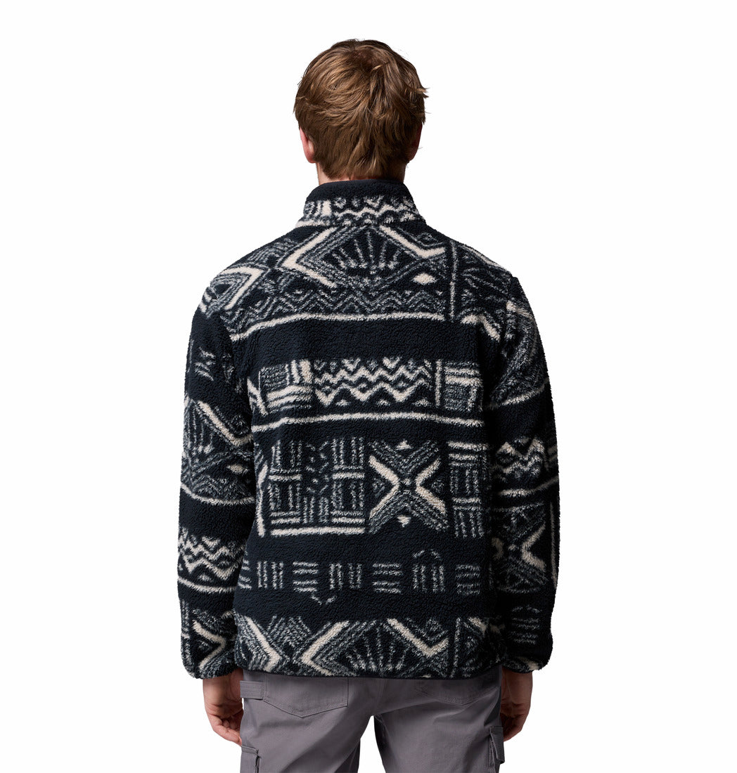 Person wearing a patterned jacket on a white background