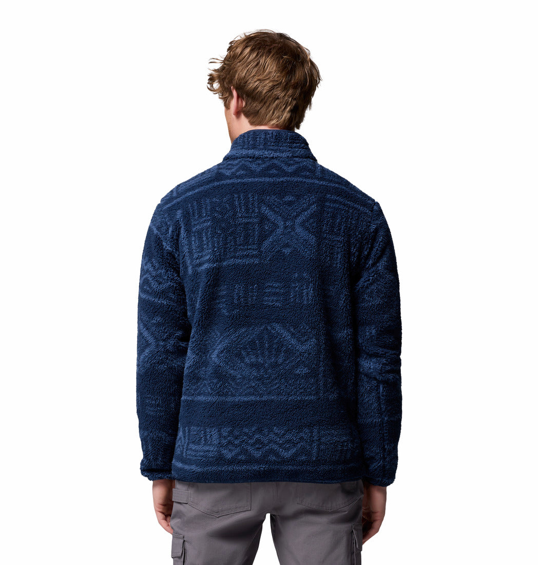 Person wearing a blue patterned fleece jacket on a white background