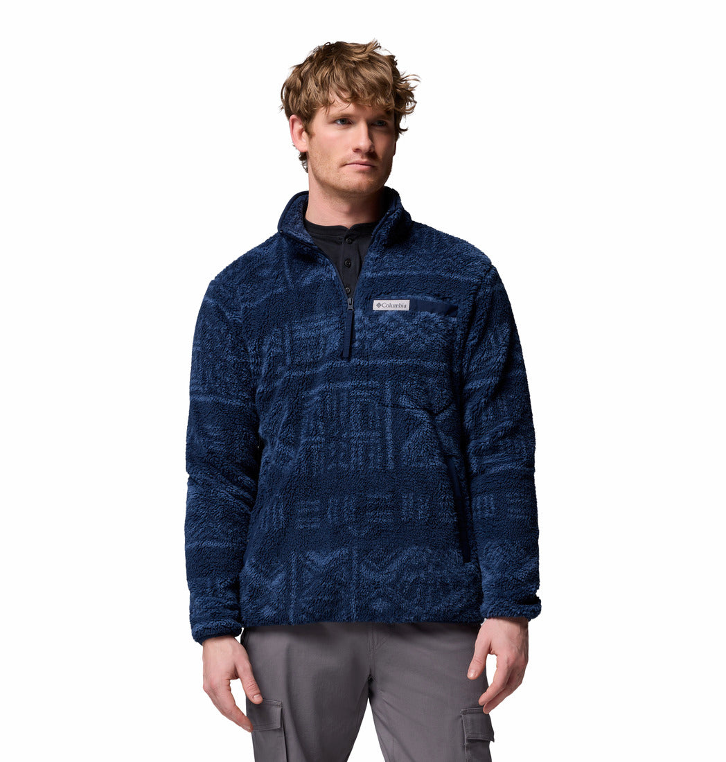 Man wearing a blue patterned pullover fleece on a white background
