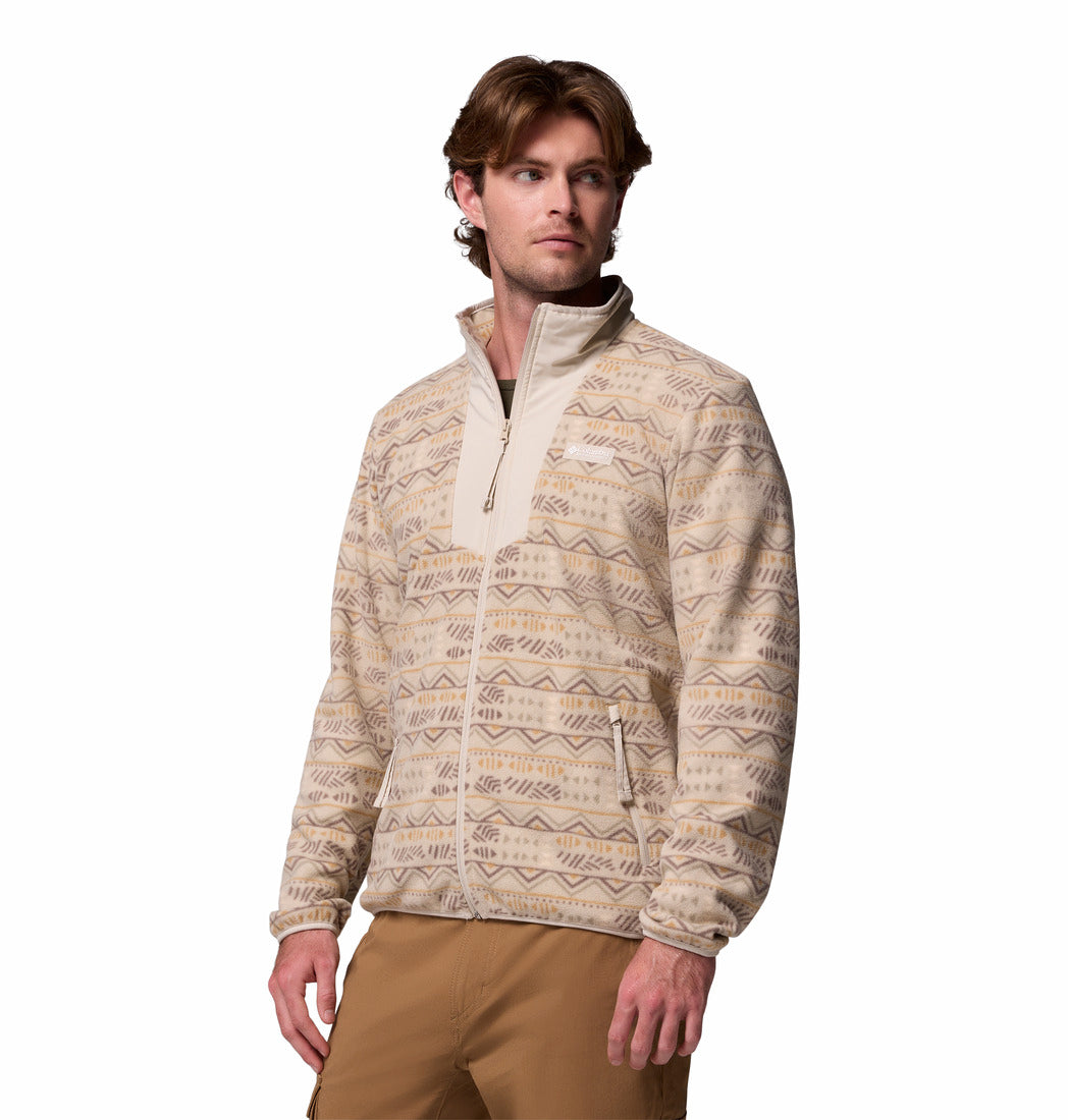 Man wearing a patterned beige sweater on a white background