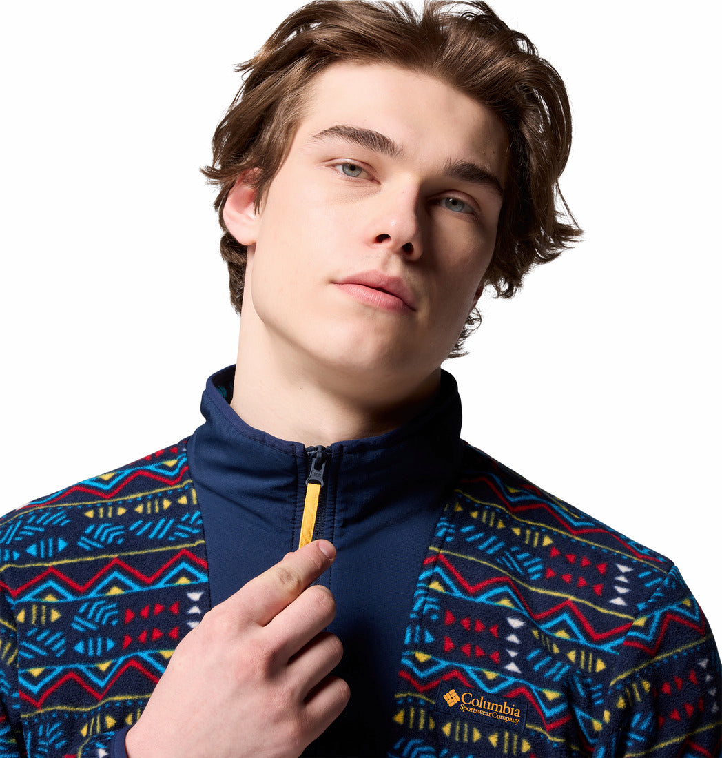 Person wearing a colorful patterned jacket with a visible brand logo on a white background