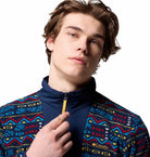 Person wearing a colorful patterned jacket with a visible brand logo on a white background