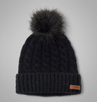 Black knit beanie with pom-pom on a gray background