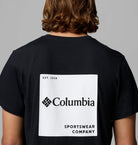 Person wearing a black Columbia Sportswear Company t-shirt with a white logo on the back.