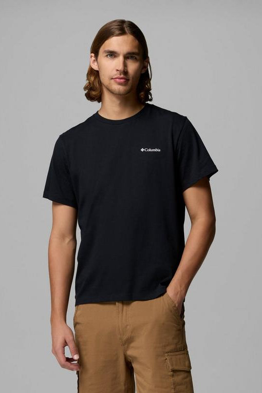 Person wearing a black t-shirt with a logo on a gray background