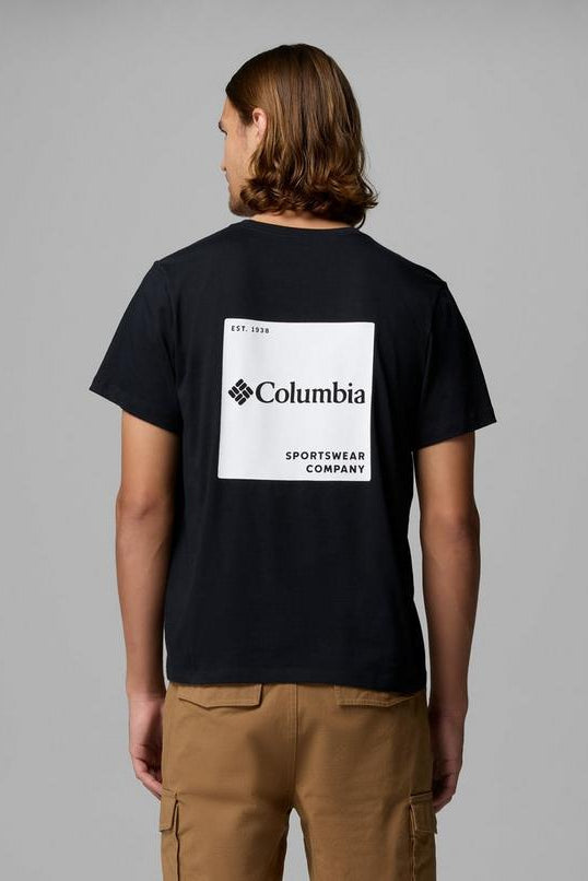 Person wearing a black t-shirt with Columbia Sportswear Company logo on the back against a gray background
