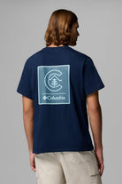 Person wearing a navy blue t-shirt with Columbia logo on the back against a gray background