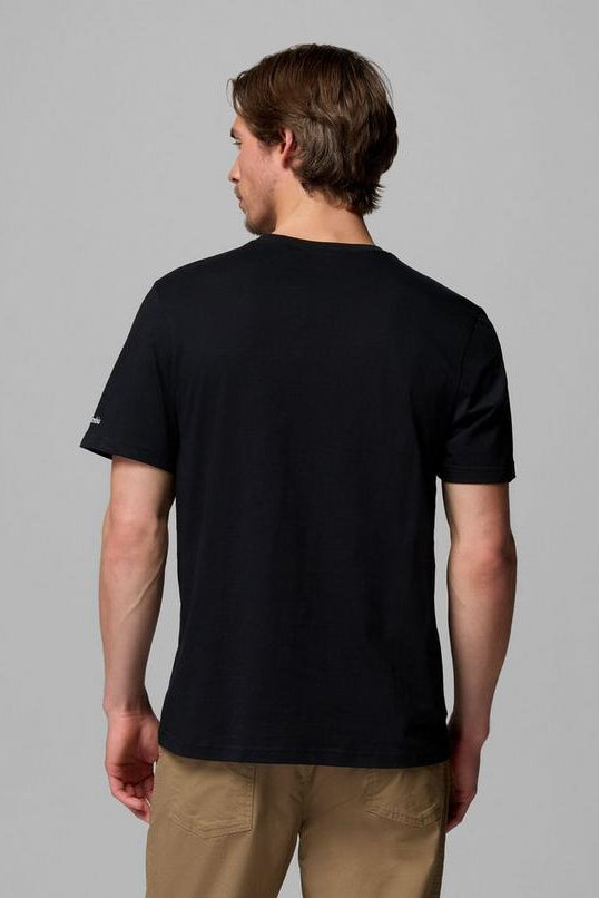 Person wearing a black t-shirt and beige pants on a gray background