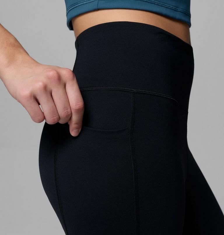 Person wearing black leggings with a gray background