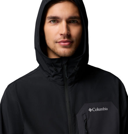 Man wearing a black Columbia jacket with the hood up on a white background