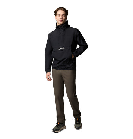 Man wearing a black Columbia sweatshirt and brown pants on a white background