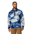 Man wearing a blue and white patterned pullover on a white background