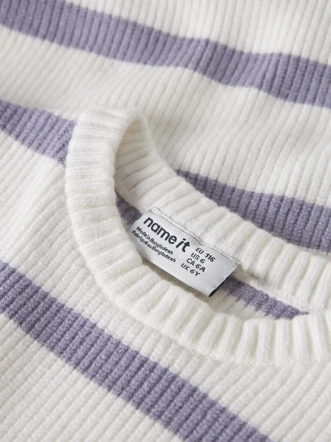 Close-up of a striped sweater with a 'name it' tag.