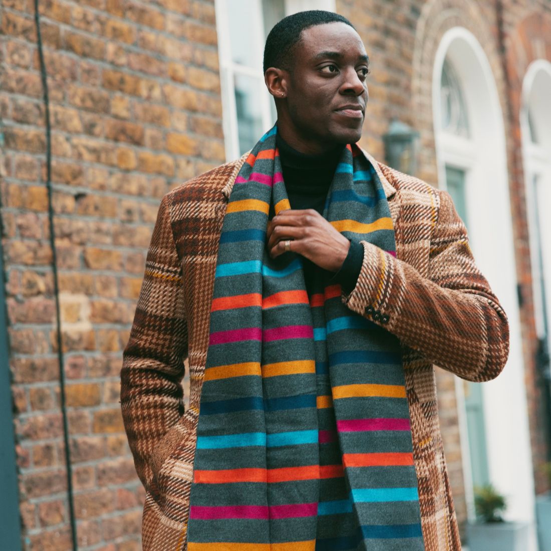 Man wearing a grey/multi stripe bamboo scarf
