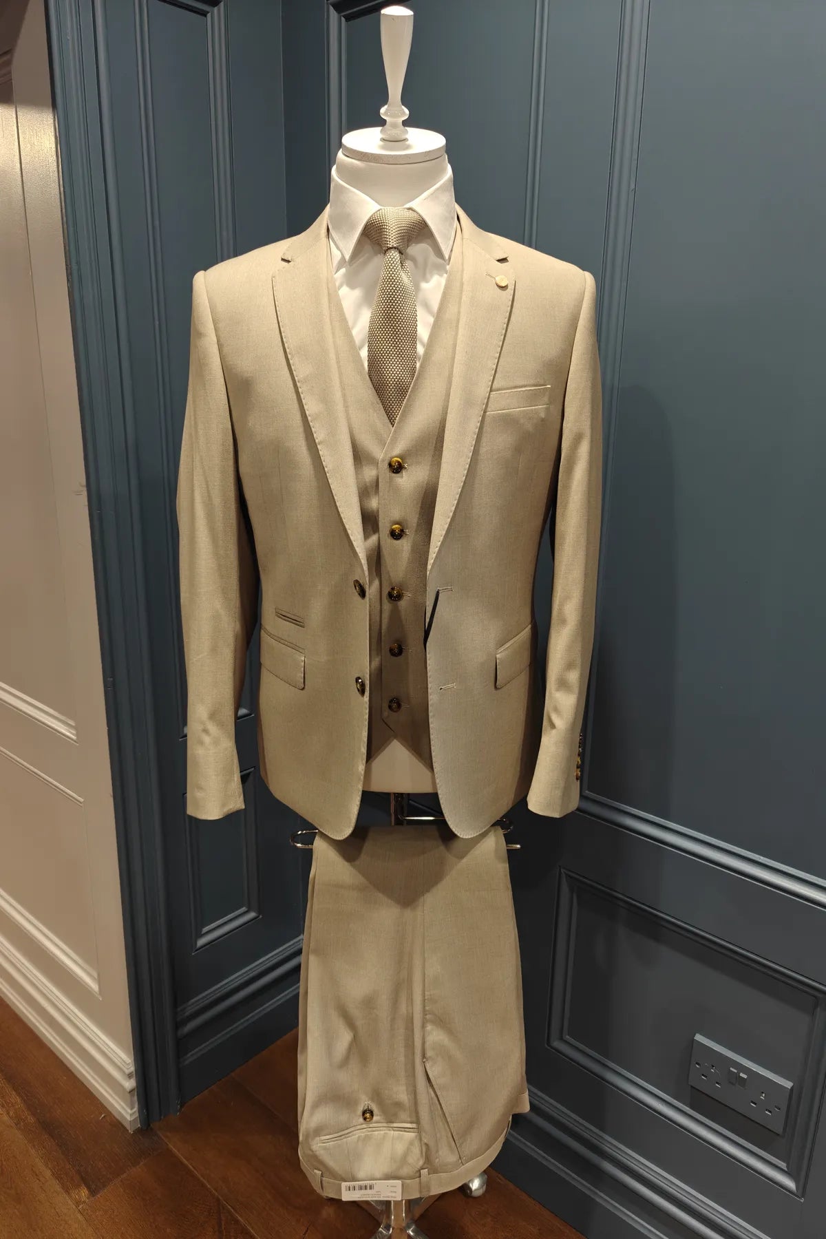 Kingsley walnut 3 piece suit from 6th Sense on a mannequin against a blue paneled wall