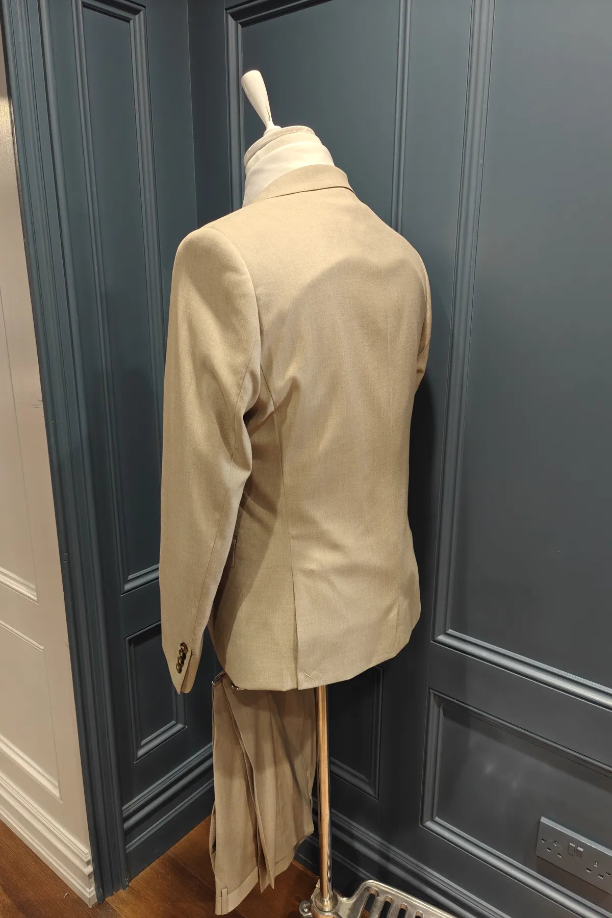 Kingsley walnut 3 piece suit from 6th Sense on a mannequin against a dark paneled wall. Back view
