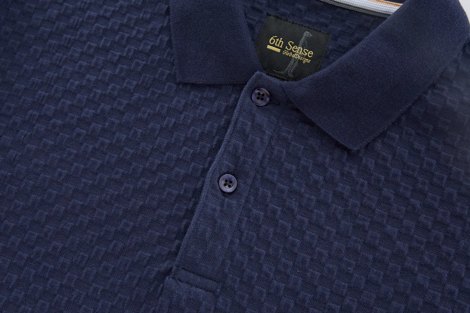 Navy blue textured polo shirt with '6th Sense' label on collar