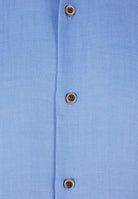 Close-up of 6th Sense Ocean Lyocell shirt showing blue fabric and buttons with orange stitching
