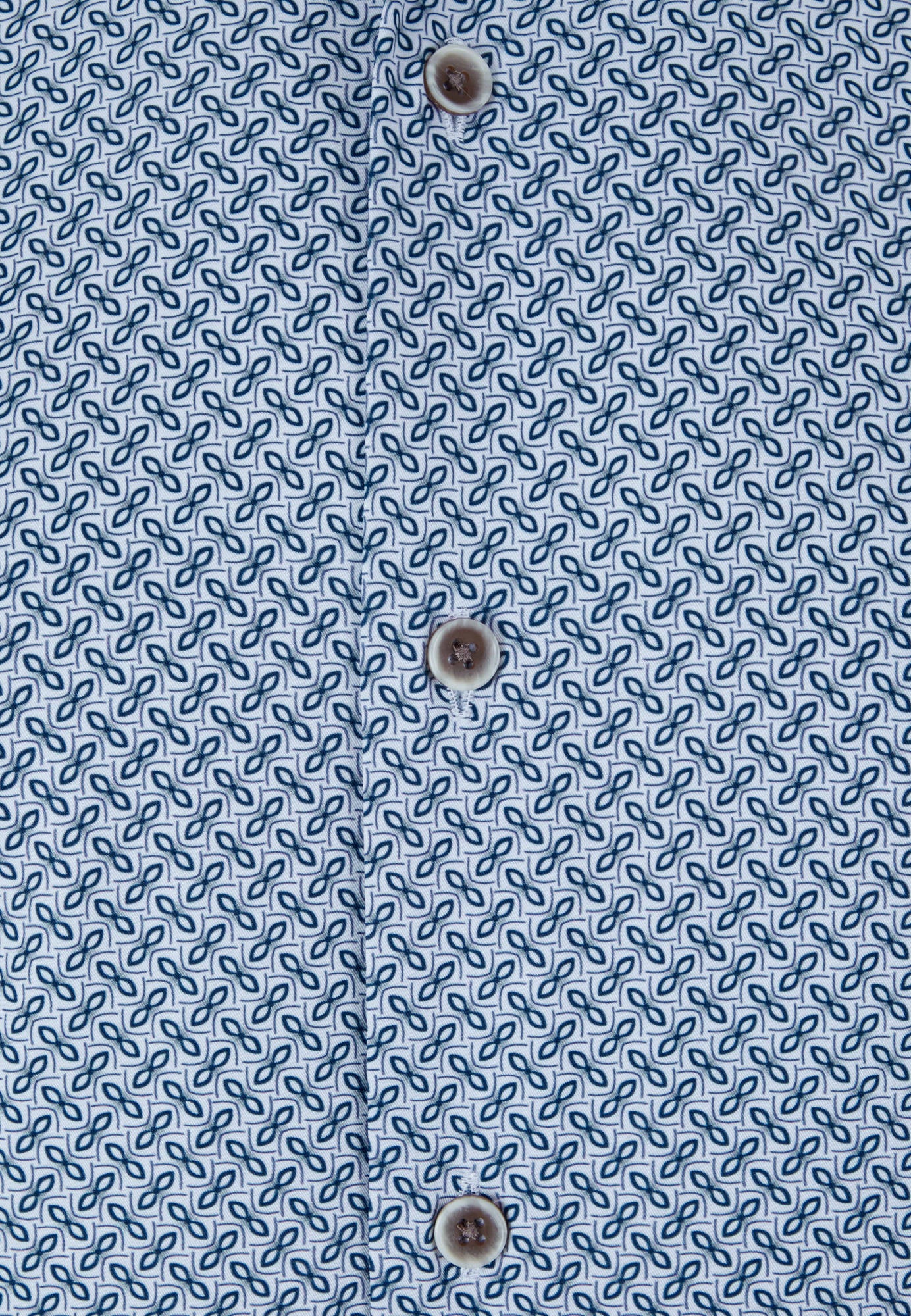 Close-up of a blue patterned fabric with button details