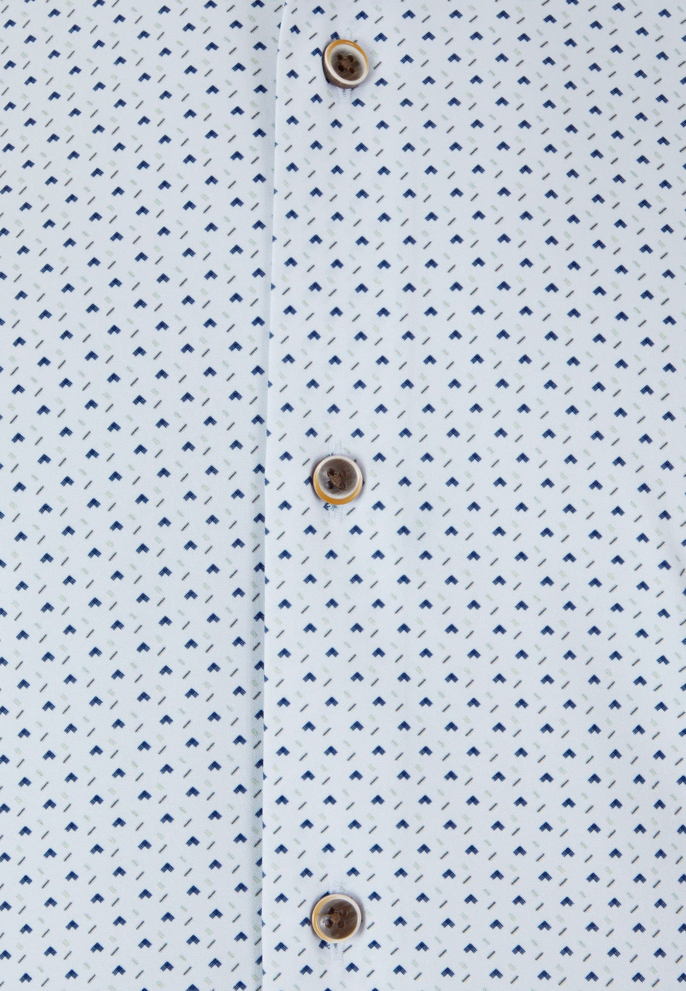 Close-up of a light blue shirt with a subtle pattern and button details.