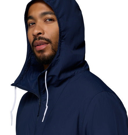 Man wearing a navy blue hooded jacket on a white background