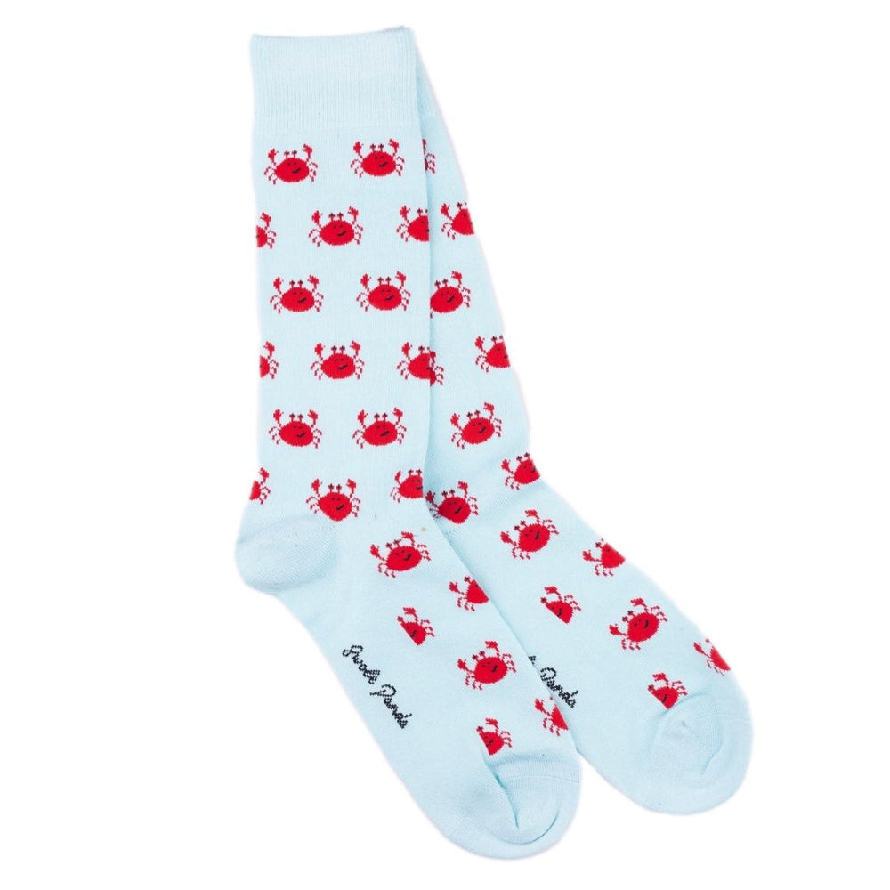 Light blue socks with red crab pattern on a white background