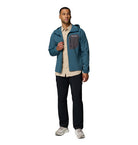 Man wearing a blue jacket with a hood on a white background