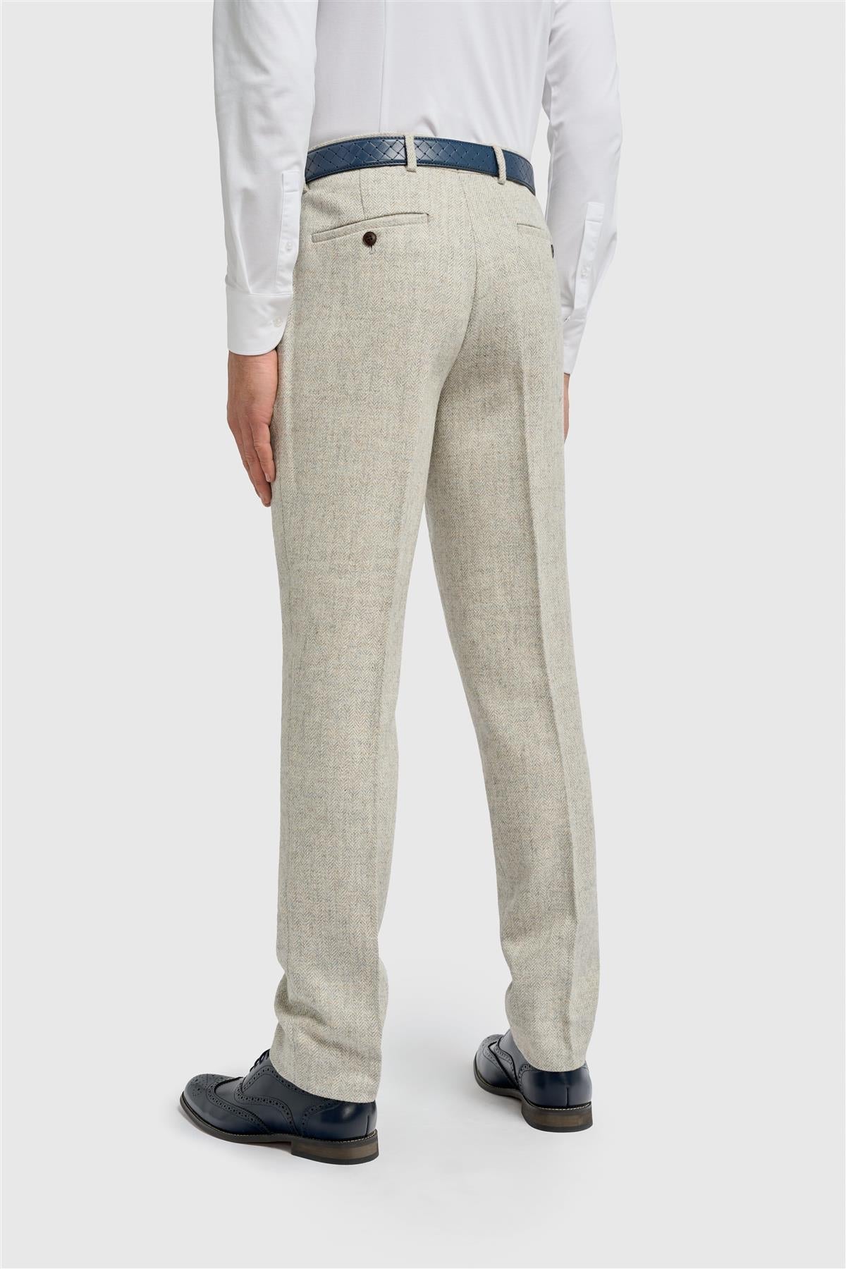 Beige tweed suit pants worn by a person on a white background