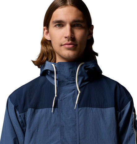 Man wearing a blue raincoat with a white background