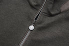 Detail of the 6th Sense peat sweat's zip fastening and round metal pull bearing the 6th Sense logo.