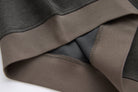 Close-up of the 6th Sense peat sweat's hem and side seam, showing contrast ribbing and stitching.