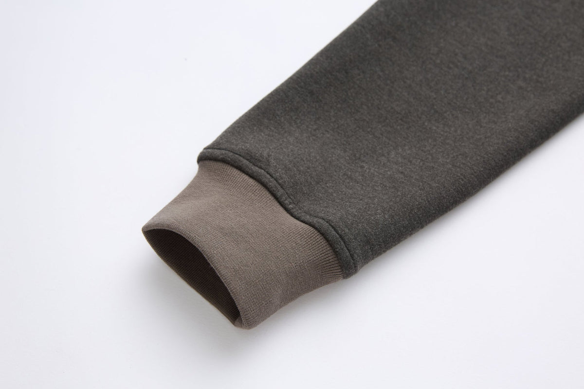 Close-up of the 6th Sense peat sweat's sleeve cuff in contrast ribbed fabric.