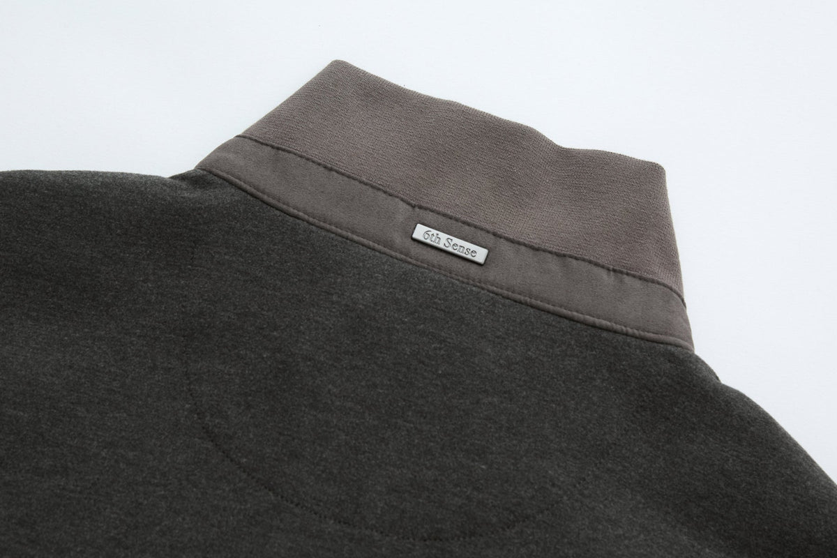 Rear collar of the 6th Sense Air Peat Gilet with ribbed peat knit and small 6th Sense label.