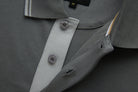 Close-up of the 6th Sense Astound December Polo showing the December grey collar, a button placket with two buttons, buttonholes, and a size M label.