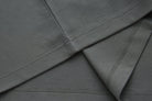 Close-up of the 6th Sense Astound December Polo in December, showing folded fabric with double-stitched seams and overlocked hems.