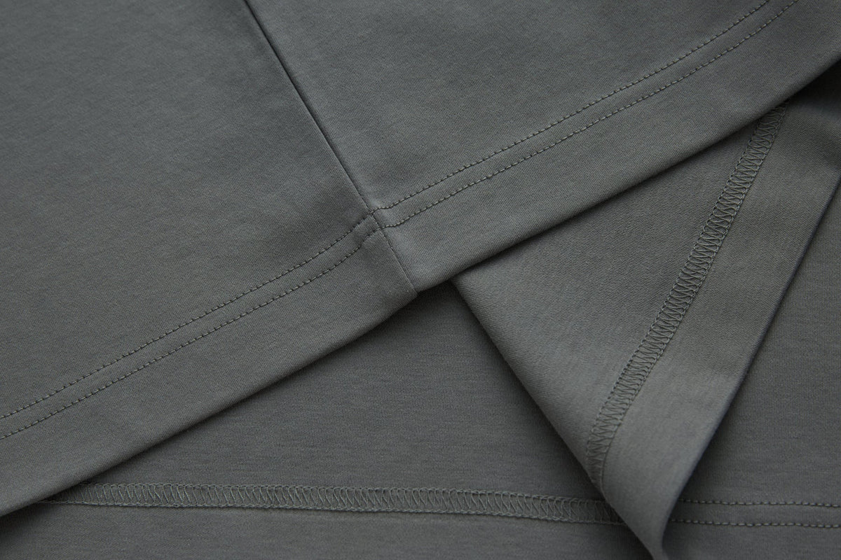 Close-up of the 6th Sense Astound December Polo in December, showing folded fabric with double-stitched seams and overlocked hems.