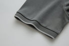 Close-up of the 6th Sense Astound December Polo in December, showing the ribbed sleeve cuff with a light stripe detail and the edge of the side seam.
