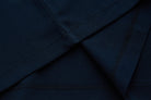Close-up of the 6th Sense Astound Eclipse Polo in Eclipse, showing folded fabric with double stitching and overlock seams.