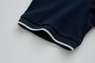 Close-up of the 6th Sense Astound Eclipse Polo sleeve cuff in Eclipse, showing a ribbed edge with a light stripe.