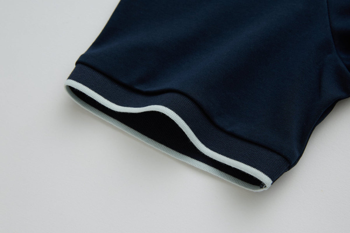 Close-up of the 6th Sense Astound Eclipse Polo sleeve cuff in Eclipse, showing a ribbed edge with a light stripe.