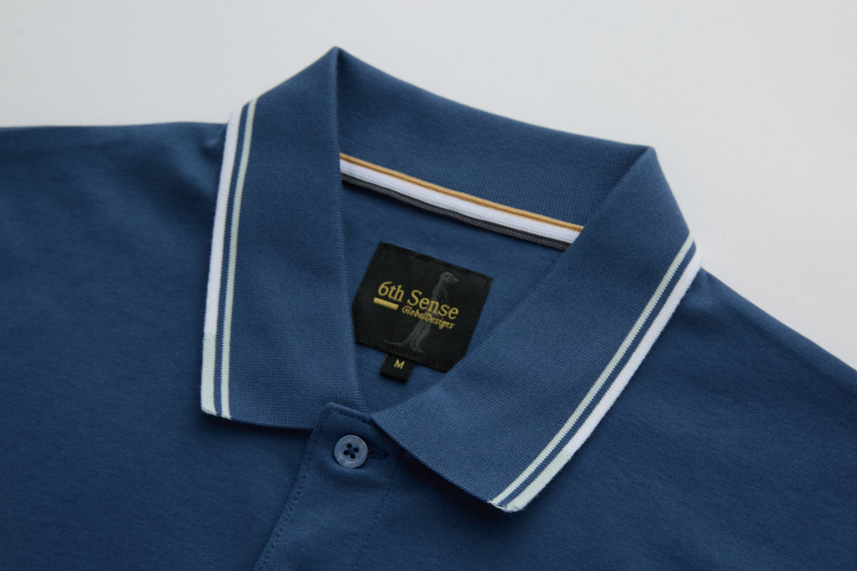 Collar detail of the 6th Sense Astound Ensign Polo showing striped tipping and inner neck label.