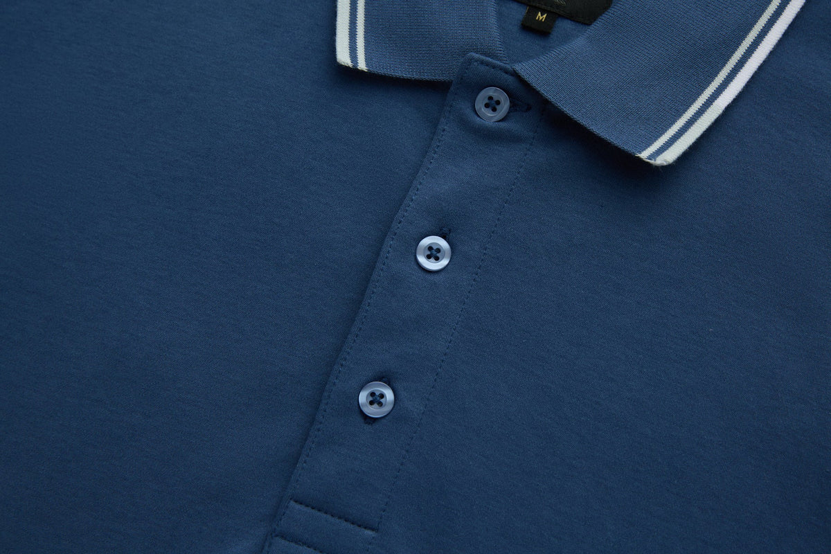 Vertical button placket of the 6th Sense Astound Ensign Polo with three buttons and collar edge.