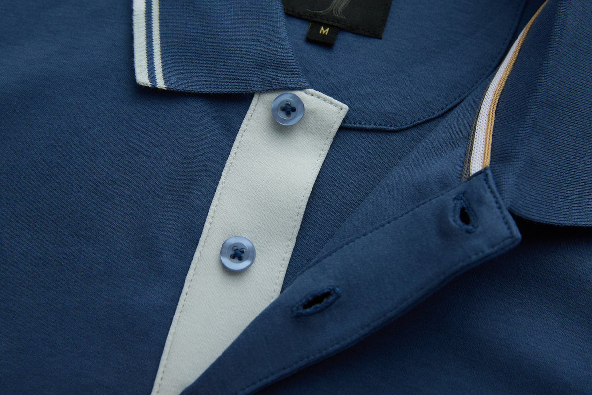 Close-up of the 6th Sense Astound Ensign Polo button placket with light contrast trim and buttons.