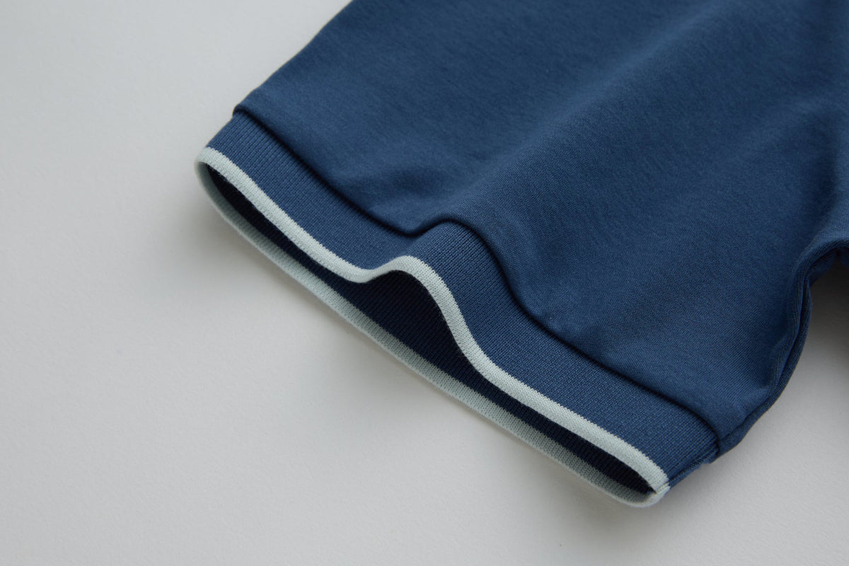 Sleeve cuff of the 6th Sense Astound Ensign Polo with light striped trim.