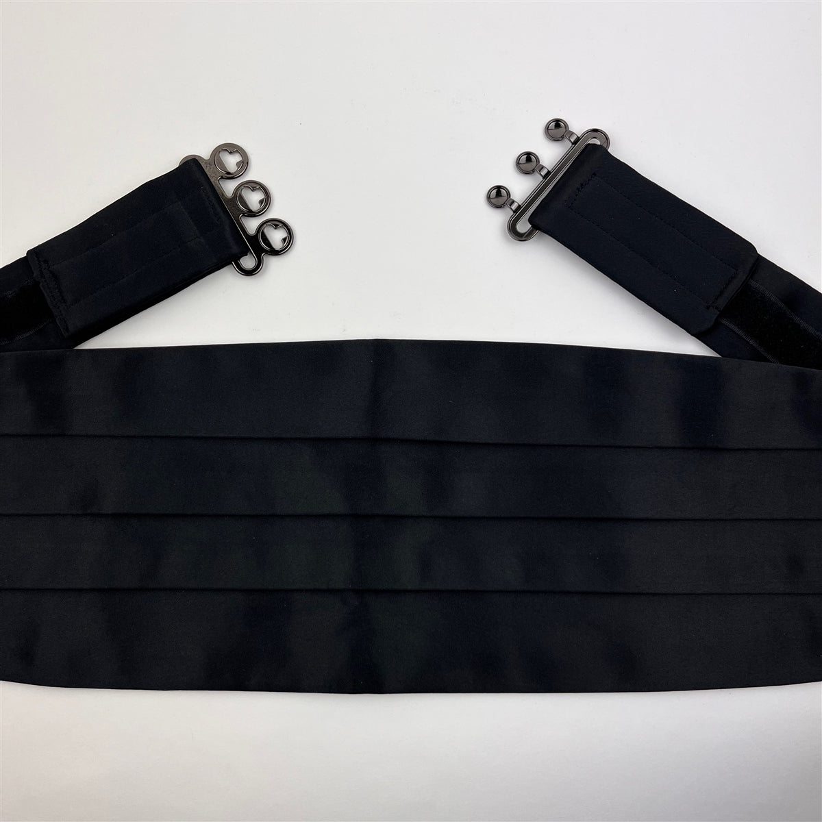 detailed close-up of a  black satin cummerbund.