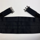 detailed close-up of a  black satin cummerbund.