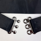 detailed close-up of a  black satin cummerbund clips